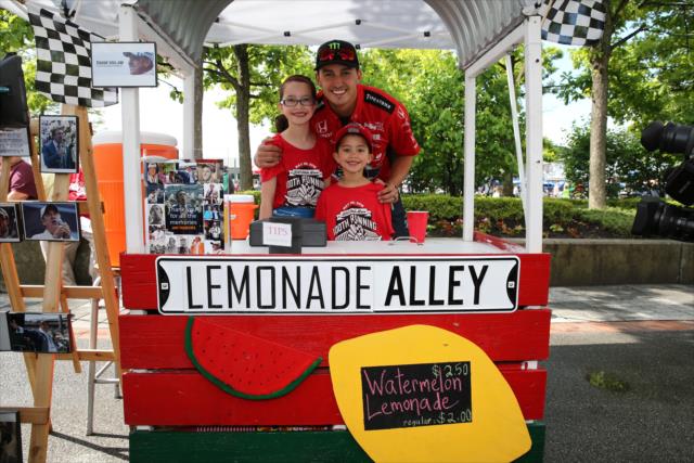 Young entrepreneurs with the help of Graham Rahal sell lemonade on Lemonade Day at the Brickyard -- Photo by: Chris Jones