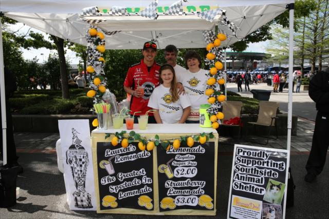 Young entrepreneurs with the help of Graham Rahal sell lemonade on Lemonade Day at the Brickyard -- Photo by: Chris Jones