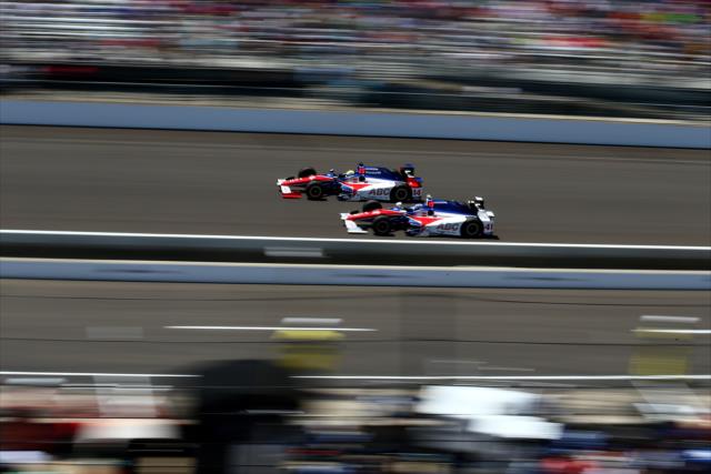 Teammates Takuma Sato and Jack Hawksworth go side-by-side down the frontstretch during the 100th Indianapolis 500 -- Photo by: Bret Kelley
