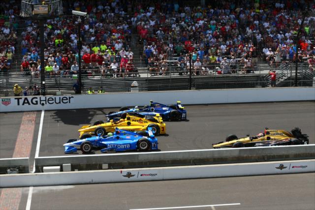 Tony Kanaan goes three-wide with Helio Castroneves and Josef Newgarden at the yard of bricks during the 100th Indianapolis 500 -- Photo by: Bret Kelley