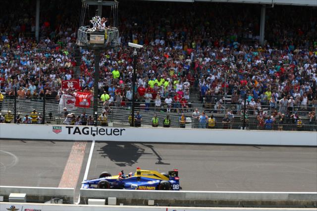 Alexander Rossi takes the twin-checkered flags to win the 100th Indianapolis 500 -- Photo by: Bret Kelley