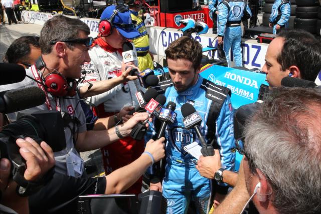 A dejected Carlos Munoz is interviewed on pit lane following his runner-up finish in the 100th Indianapolis 500 -- Photo by: Chris Jones