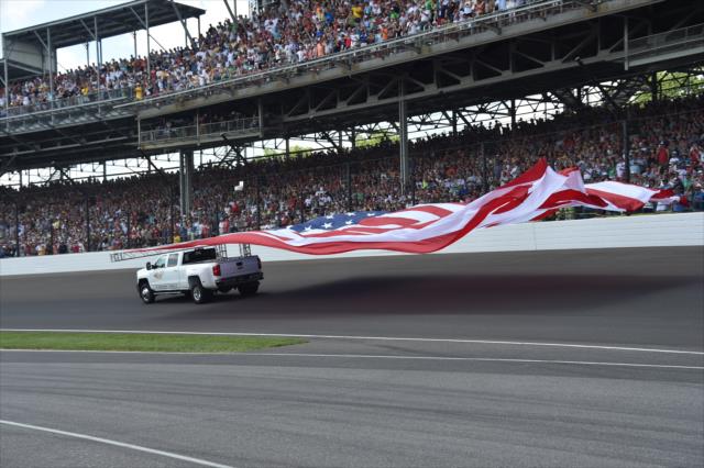 American Flag waves across the Indianapolis Motor Speedway prior to the 100th Running of the Indy 500 presented by PennGrade Motor Oil -- Photo by: Dana Garrett
