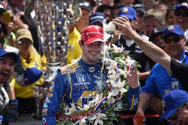 Alexander Rossi with a cold shower of milk in Victory Circle following his victory in the 100th Indianapolis 500 -- Photo by: Dana Garrett
