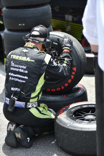 Chip Ganassi Racing review tires following a pit stop for Charlie Kimball during the 100th Indianapolis 500 -- Photo by: Eric Anderson
