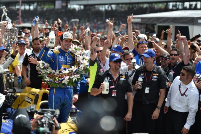 Alexander Rossi toasts with ice cold milk in Victory Circle following his win in the 100th Indianapolis 500 -- Photo by: Eric Anderson