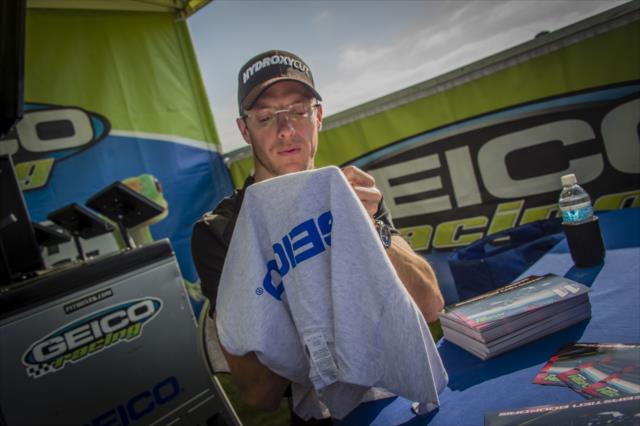 Sebastien Bourdais signs an autograph in the Geico Racing area of Fan Village at the Indianapolis Motor Speedway -- Photo by: Forrest Mellott