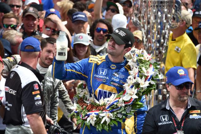 Alexander Rossi toasts with ice cold milk in Victory Circle following his win in the 100th Indianapolis 500 -- Photo by: John Cote