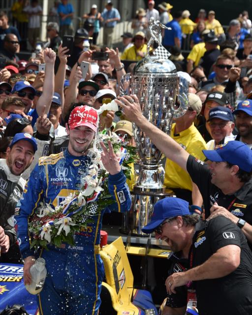 Alexander Rossi receives a cold shower of milk in Victory Circle following his win in the 100th Indianapolis 500 -- Photo by: John Cote