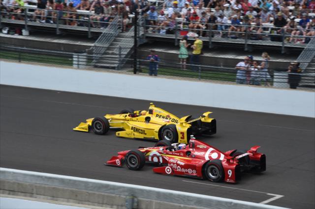 Previous Indy 500 winners Helio Castroneves and Scott Dixon racing each other for position during the 100th Running of the Indianapolis 500. -- Photo by: Jim Haines