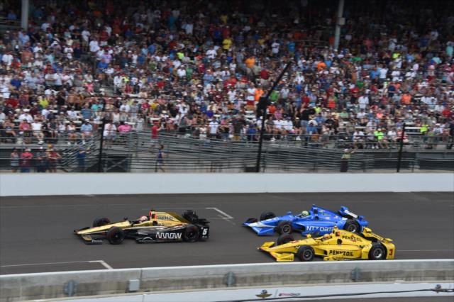 James Hinchcliffe leads Helio Castroneves and Tony Kanaan down the frontstraight during the 100th Indianapolis 500 -- Photo by: Jim Haines