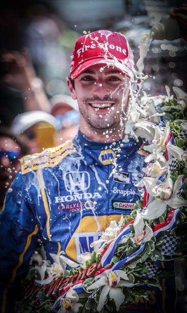 Alexander Rossi with a cold shower of milk in Victory Circle following his win in the 100th Indianapolis 500 -- Photo by: Shawn Gritzmacher