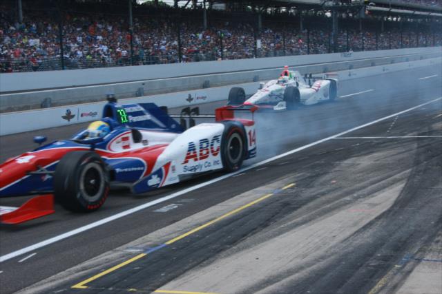 Takuma Sato and Oriol Servia peel out of pit lane during the 100th Indianapolis 500 -- Photo by: Leigh Spargur
