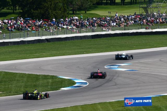 Cars speed through the turns during the INDYCAR GP -- Photo by: Bret Kelley