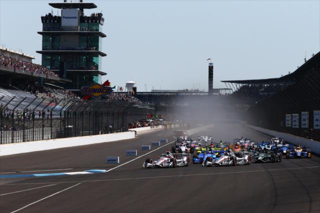 There is a little smoke as drivers head into Turn 1 of the INDYCAR GP -- Photo by: Bret Kelley