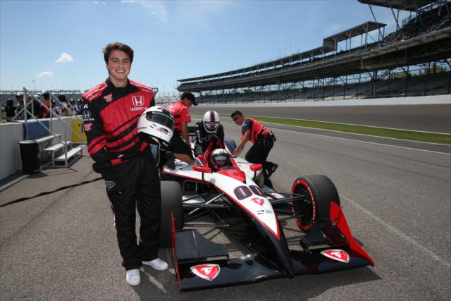 Member of Forever In Your Mind takes a two-seater ride with Mario Andretti -- Photo by: Chris Jones
