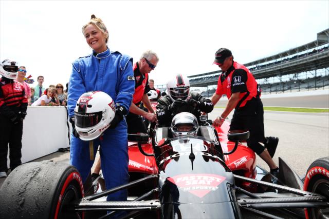 Alicia Silverstone prepares to take a ride with Mario Andretti -- Photo by: Chris Jones