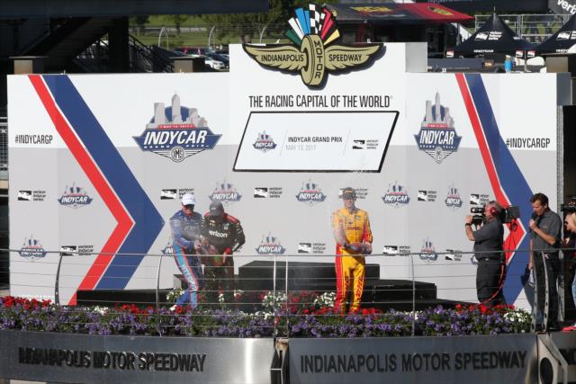 The podium of Will Power, Scott Dixon, and Ryan Hunter-Reay spray the champagne in Victory Circle -- Photo by: Chris Jones