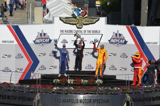 Will Power, Scott Dixon, and Ryan Hunter-Reay hoist their trophies in Victory Circle following the INDYCAR Grand Prix -- Photo by: Jim Haines