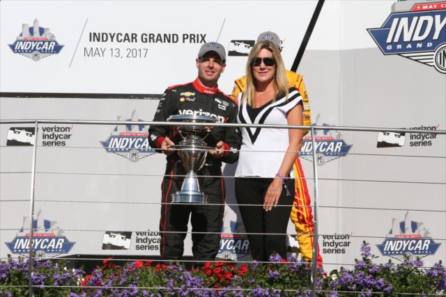 Will Power accepts the Winner's Trophy from Nancy George in Victory Circle following the INDYCAR Grand Prix -- Photo by: Joe Skibinski