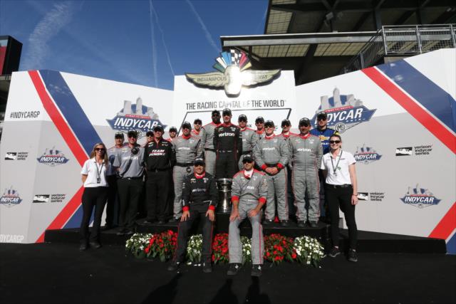 Will Power's team poses for a picture on Victory Podium -- Photo by: Joe Skibinski