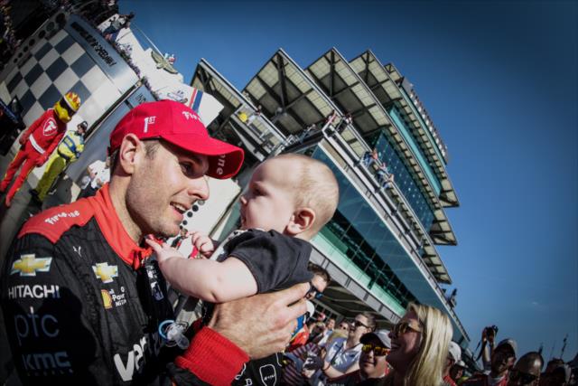 Will Power celebrates with his son after winning the INDYCAR GP -- Photo by: Shawn Gritzmacher