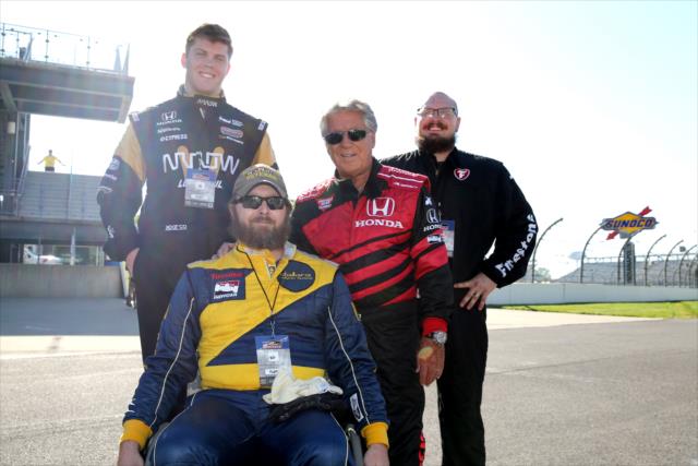 Members of the Wounded Veterans Foundation with Mario Andretti prior to their two-seater rides around the Indianapolis Motor Speedway -- Photo by: Chris Jones