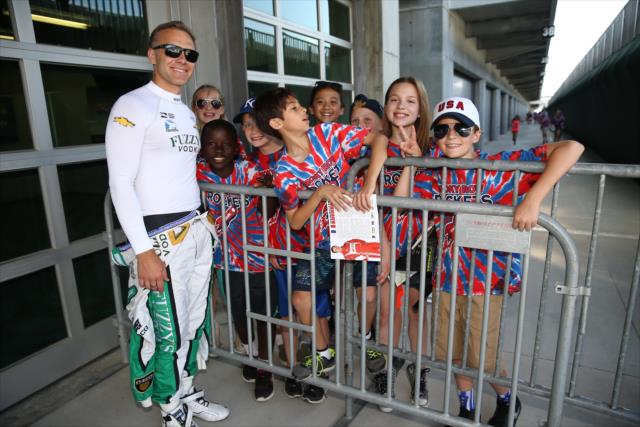 Ed Carpenter poses for a photograph with a few young fans prior to practice for the 101st Indianapolis 500 -- Photo by: Chris Jones