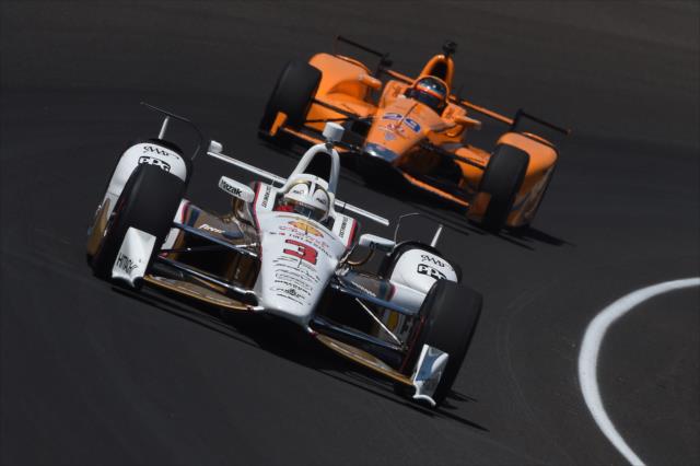 Helio Castroneves and Fernando Alonso go nose-to-tail through Turn 1 during practice for the 101st Indianapolis 500 -- Photo by: Chris Owens