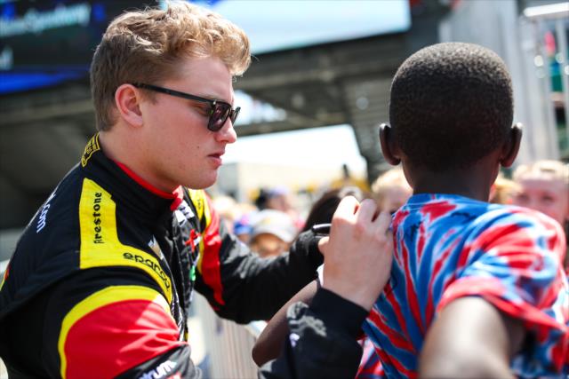 Sage Karam signs an autograph for a young fan prior to practice for the 101st Indianapolis 500 -- Photo by: David Yowe