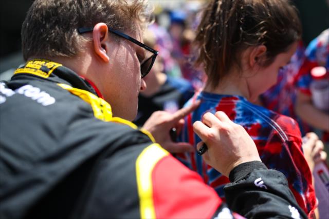 Sage Karam signs an autograph for a young fan prior to practice for the 101st Indianapolis 500 -- Photo by: David Yowe