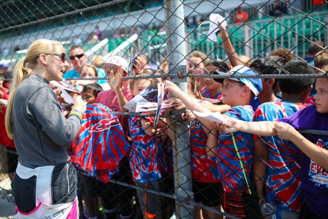 Fan favorite Pippa Mann signs a few autographs along pit lane prior to practice for the 101st Indianapolis 500 -- Photo by: David Yowe