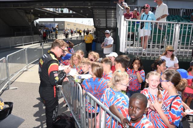Sage Karam signs a few autographs for some young fans along pit lane prior to practice for the 101st Indianapolis 500 -- Photo by: Jim Haines