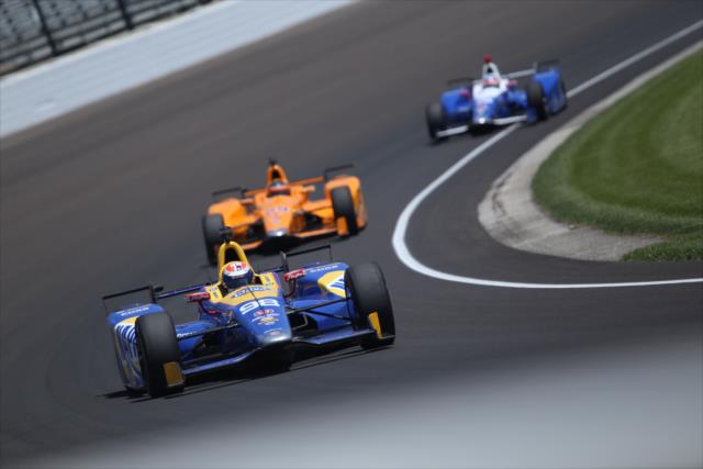 Alexander Rossi leads a group through Turn 3 during practice for the 101st Indianapolis 500 -- Photo by: Matt Fraver