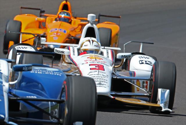 Helio Castroneves mixes it up through Turn 1 during practice for the 101st Indianapolis 500 -- Photo by: Mike Harding