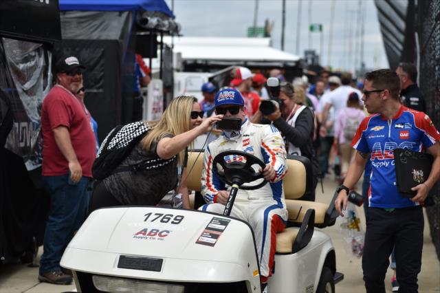 Conor Daly takes a picture with a fan -- Photo by: Dana Garrett