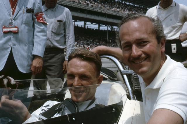Legendary automotive engineer Colin Chapman poses with Dan Gurney following qualifications for the 1964 Indianapolis 500