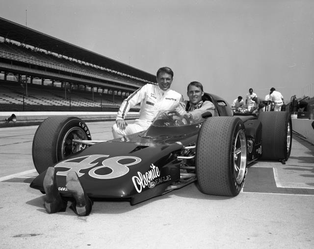 Dan Gurney with NBA star Rick Barry on pit lane prior to practice for the 1969 Indianapolis 500