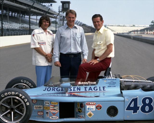 Dan Gurney stands with Wayne Leary and Bobby Unser following Unser's 1975 Indy 500 victory
