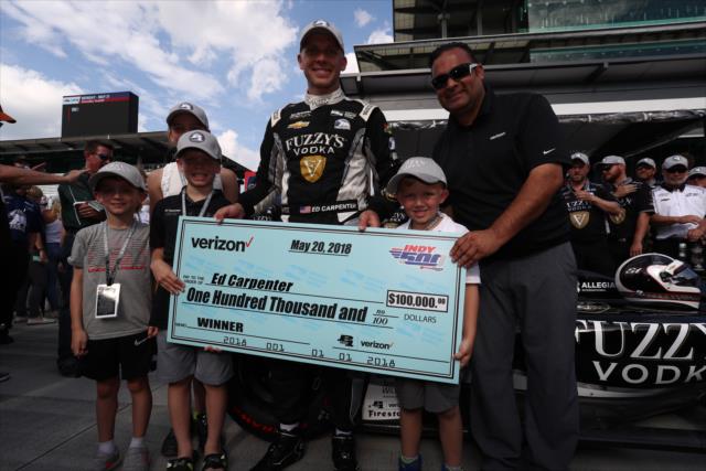 Ed Carpenter is presented his check from Verizon after winning the pole position for the 102nd Indianapolis 500 at the Indianapolis Motor Speedway -- Photo by: Chris Jones