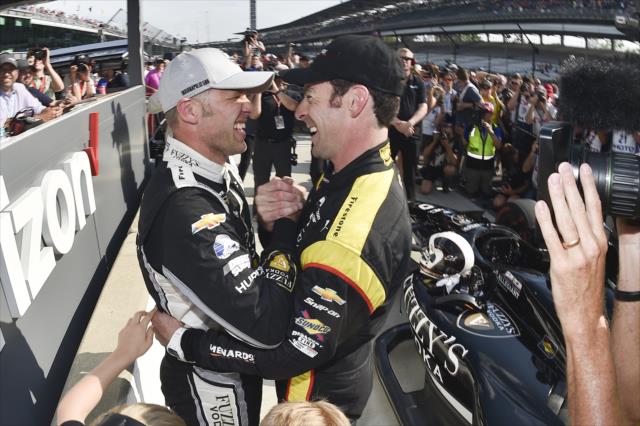 Ed Carpenter is congratulated by Simon Pagenaud on pit lane after winning the pole position for the 102nd Indianapolis 500 at the Indianapolis Motor Speedway -- Photo by: Chris Owens