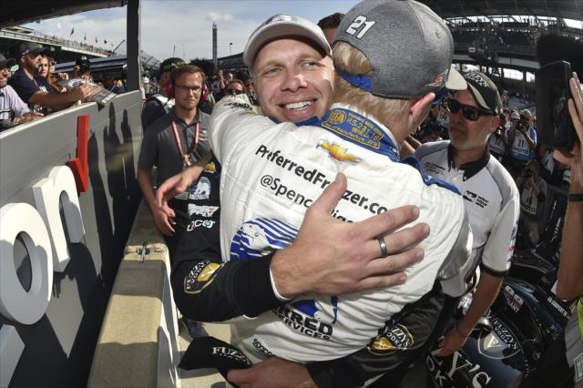 Ed Carpenter gets a congratulatory hug from his teammate Spencer Pigot after winning the pole position for the 102nd Indianapolis 500 at the Indianapolis Motor Speedway -- Photo by: Chris Owens