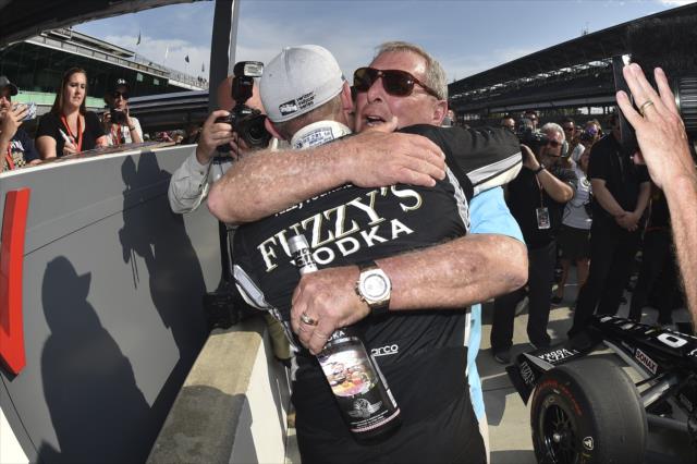 Ed Carpenter gets a big hug from Fuzzy Zoeller on pit lane after winning the pole position for the 102nd Indianapolis 500 at the Indianapolis Motor Speedway -- Photo by: Chris Owens