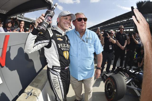 Ed Carpenter and Fuzzy Zoeller celebrate on pit lane after winning the pole position for the 102nd Indianapolis 500 at the Indianapolis Motor Speedway -- Photo by: Chris Owens