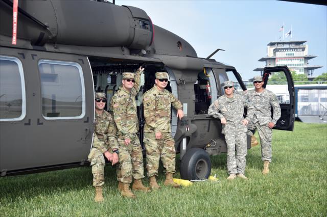Soldiers and airmen stand beside the Black Hawk helicopter parked in the infield on Crown Royal Armed Forces Qualifying Weekend at the Indianapolis Motor Speedway -- Photo by: Dana Garrett