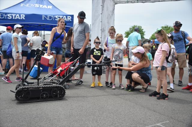 A bomb diffusing robot greets kids in the INDYCAR Fan Village at the Indianapolis Motor Speedway -- Photo by: Dana Garrett