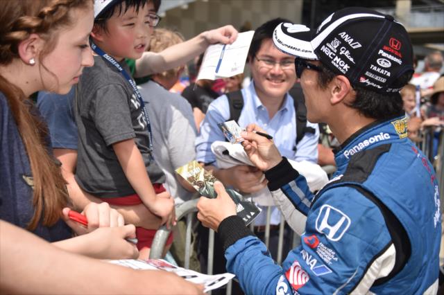 Takuma Sato stops to give his autograph to a few fans during the second day of qualifying for the 102nd Indy 500. -- Photo by: Dana Garrett