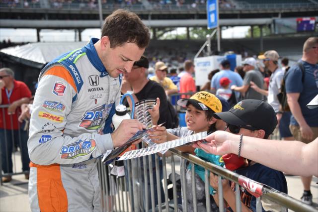 Stefan Wilson signs an autograph along pit lane following his qualification attempt for the 102nd Indianapolis 500 at the Indianapolis Motor Speedway -- Photo by: Dana Garrett