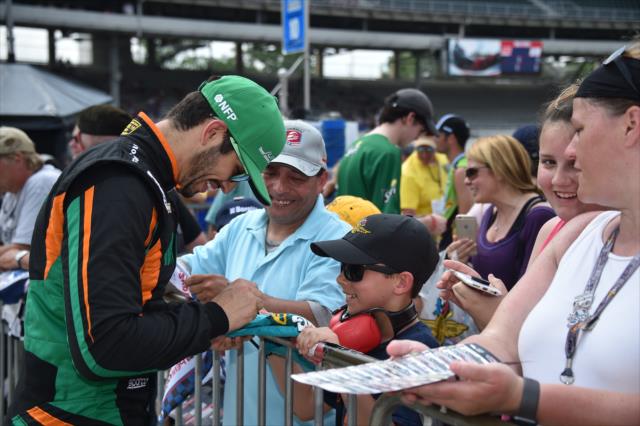 Kyle Kaiser signs a few autographs along pit lane following his qualification attempt for the 102nd Indianapolis 500 at the Indianapolis Motor Speedway -- Photo by: Dana Garrett