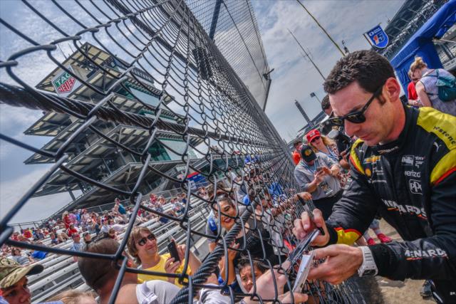 Simon Pagenaud signs autographs along pit lane prior to qualifications for the 102nd Indianapolis 500 at the Indianapolis Motor Speedway -- Photo by: Doug Mathews